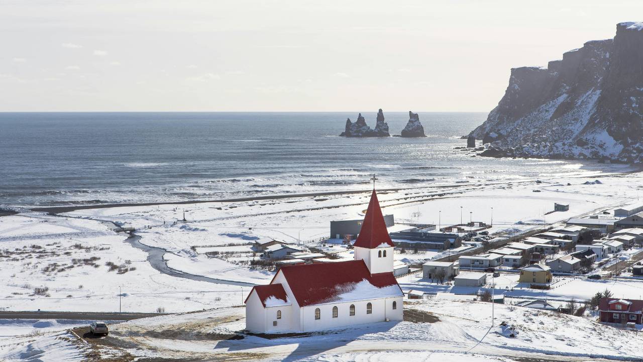 An Icelandic church with a town in the background 