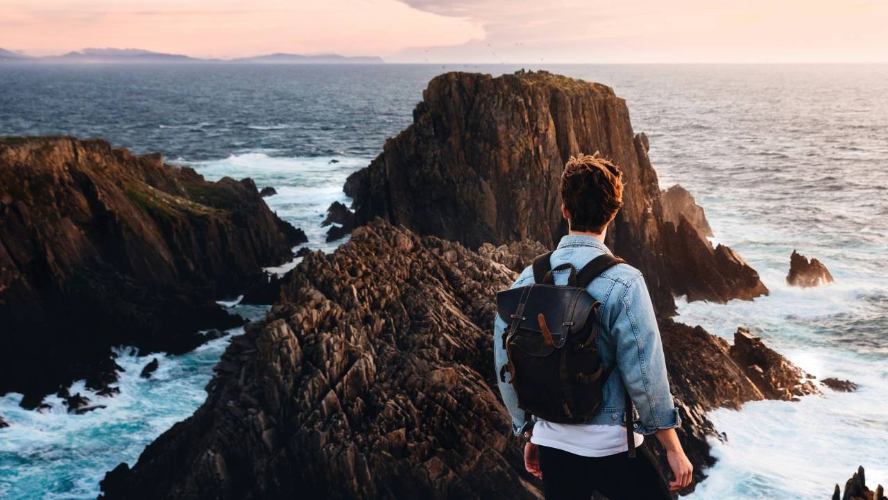 A man standing on the coast of the sea